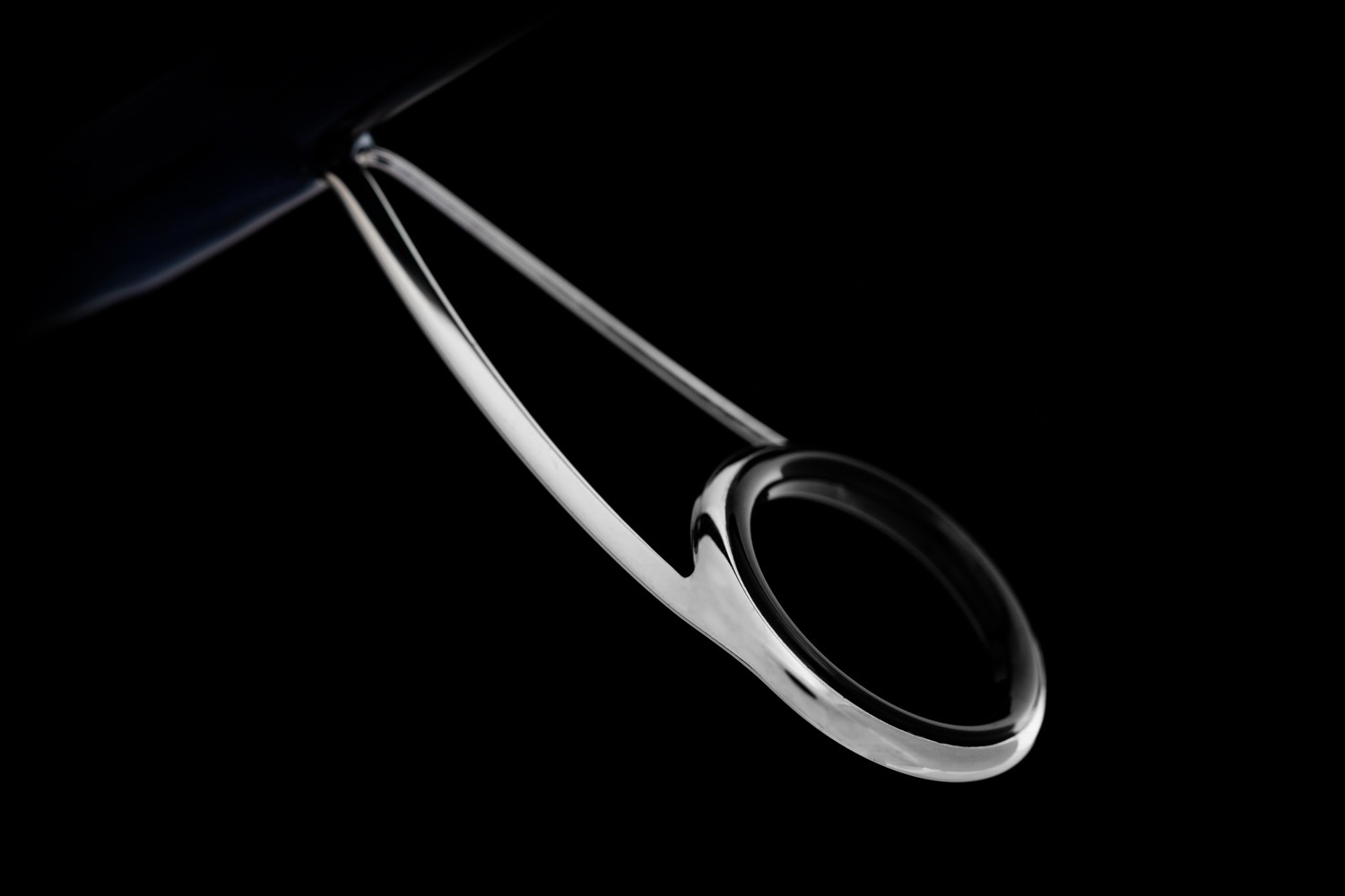 Close-up of metallic object in dark setting.