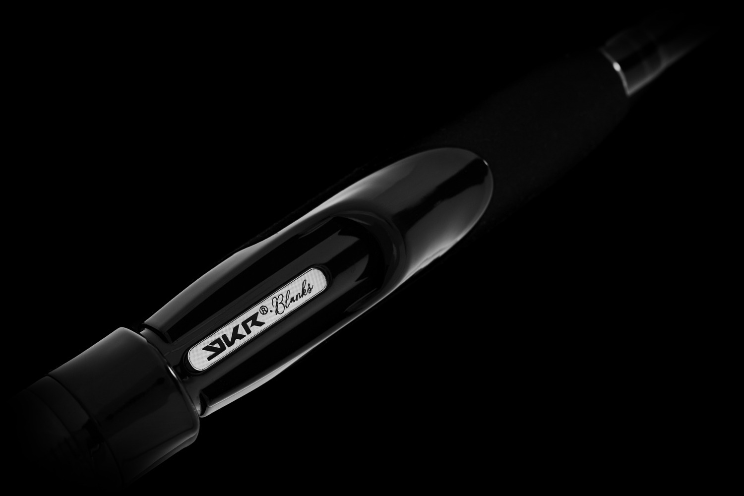 Close-up of black fishing rod with logo.