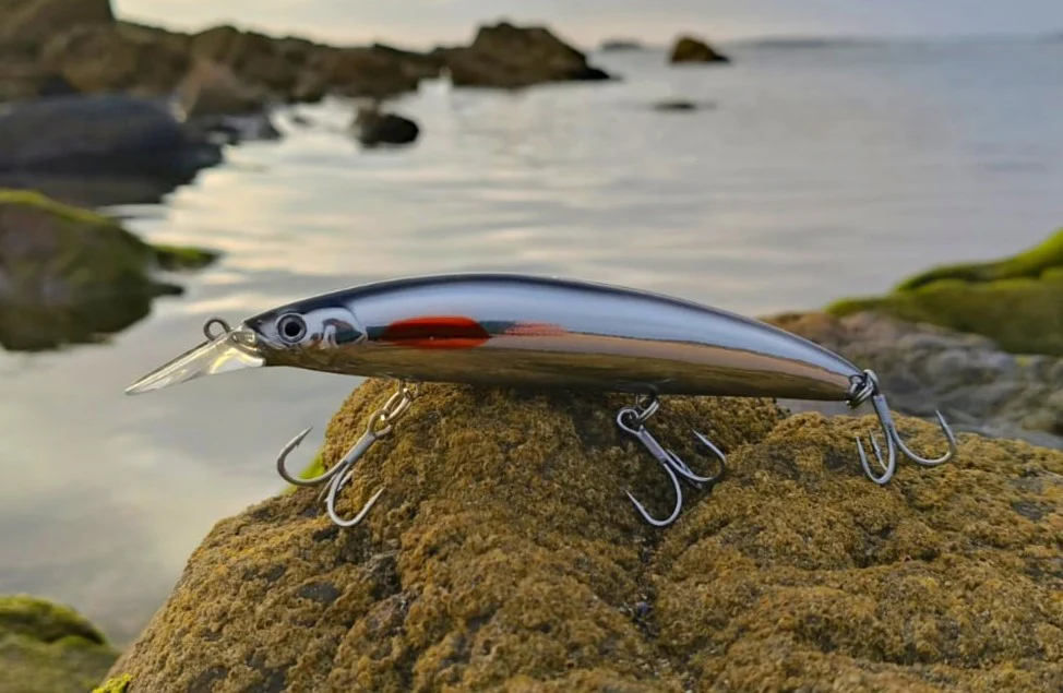 Fishing lure on rocks by the sea